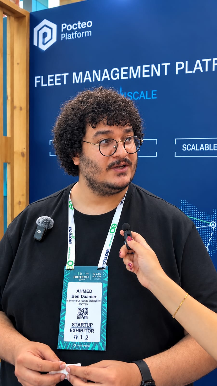 Ahmed Ben Daamer, Senior Software Engineer and Pocteo Ambassador, being interviewed in front of the Pocteo Platform backdrop